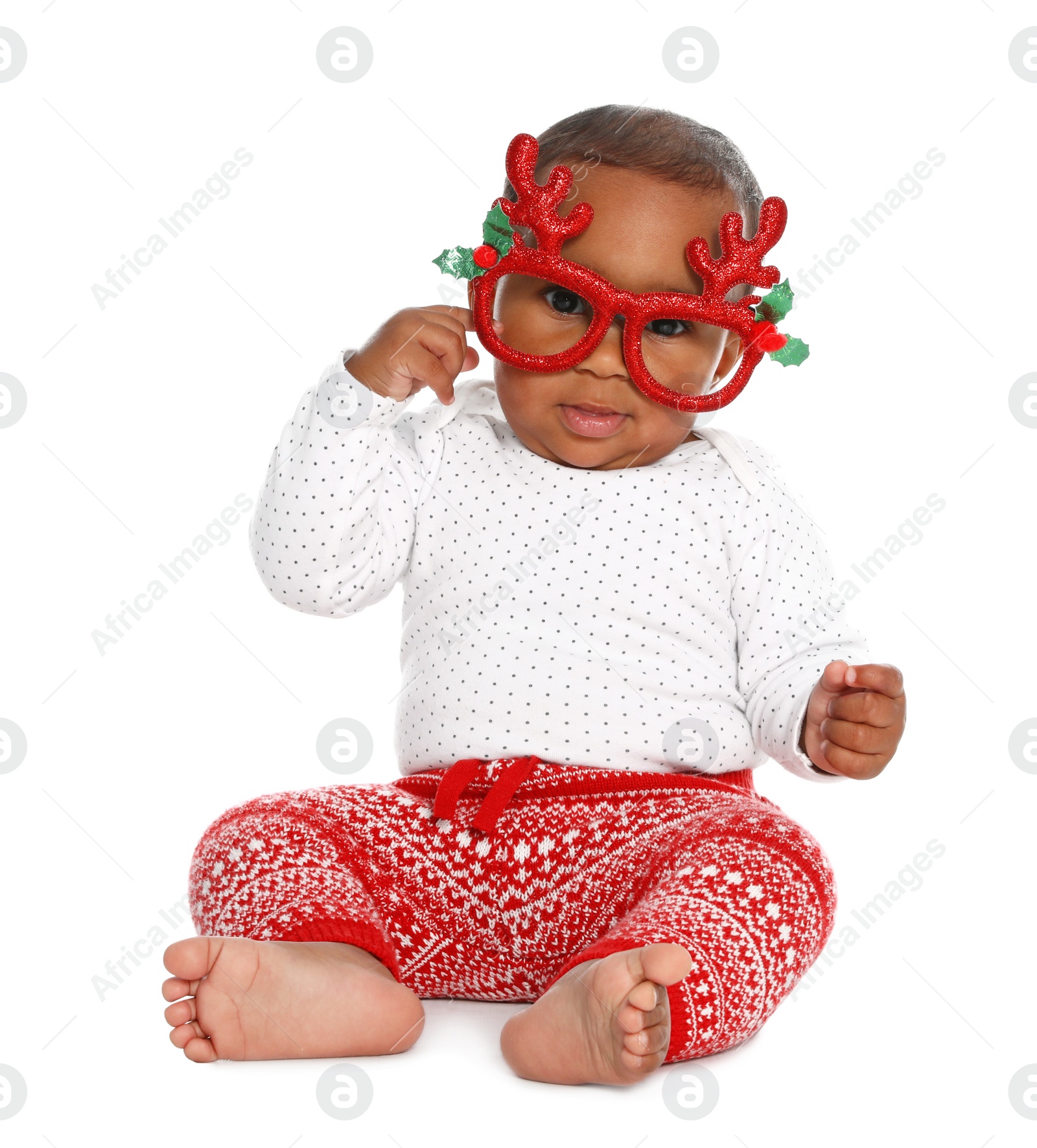 Photo of Cute African-American baby wearing funny glasses on white background. First Christmas