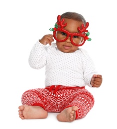 Photo of Cute African-American baby wearing funny glasses on white background. First Christmas