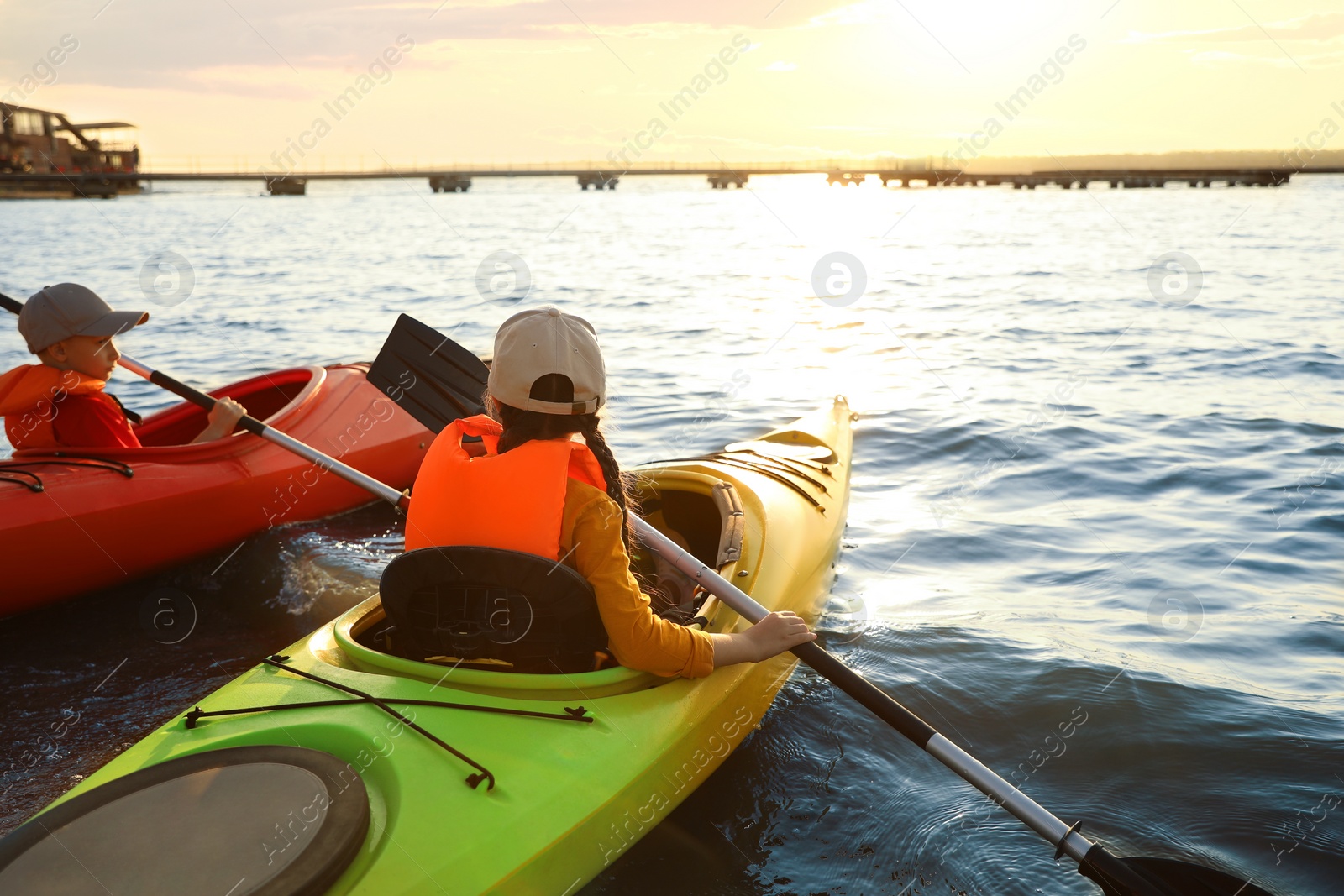 Photo of Little children kayaking on river. Summer camp activity