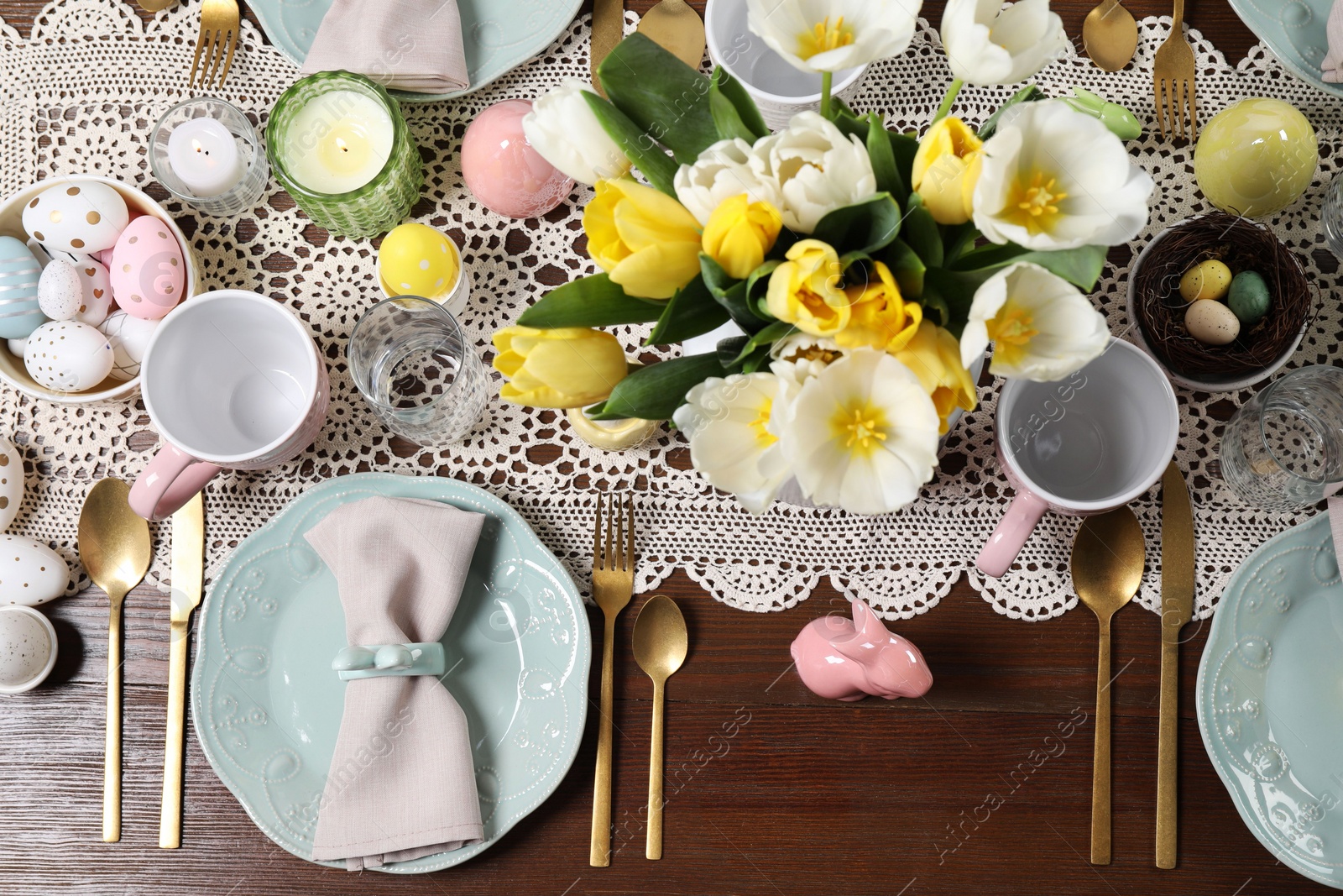 Photo of Festive table setting with beautiful flowers, flat lay. Easter celebration