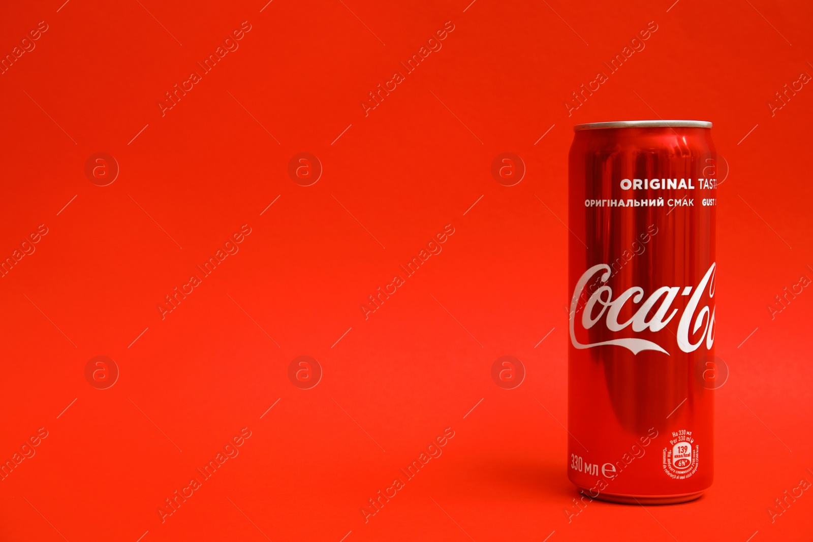 Photo of MYKOLAIV, UKRAINE - NOVEMBER 14, 2018: Coca-Cola can on color background. Space for text