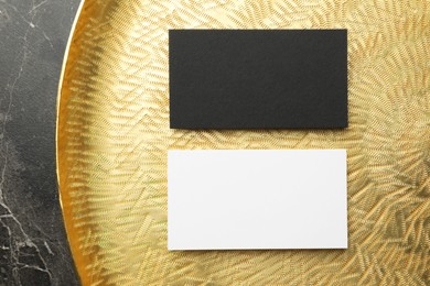 Photo of Blank business card on black textured background, top view. Mockup for design