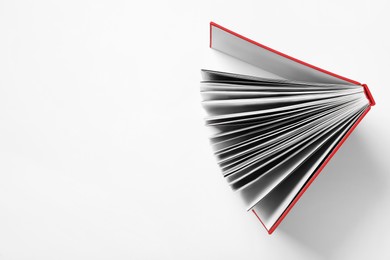 Photo of Book with red cover on white background, top view