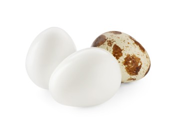 Photo of Unpeeled and peeled boiled quail eggs on white background