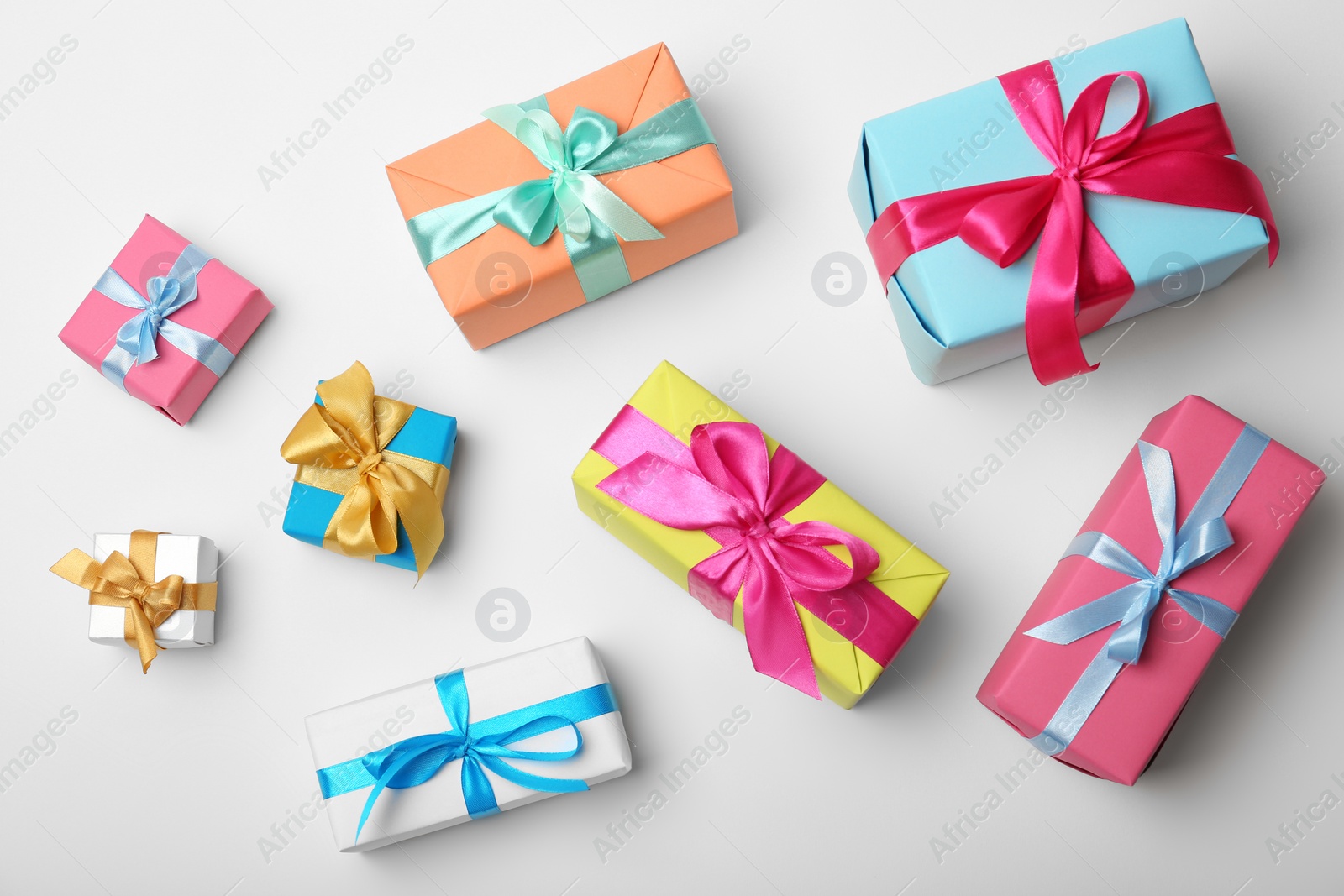 Photo of Flat lay composition with beautiful gift boxes on white background