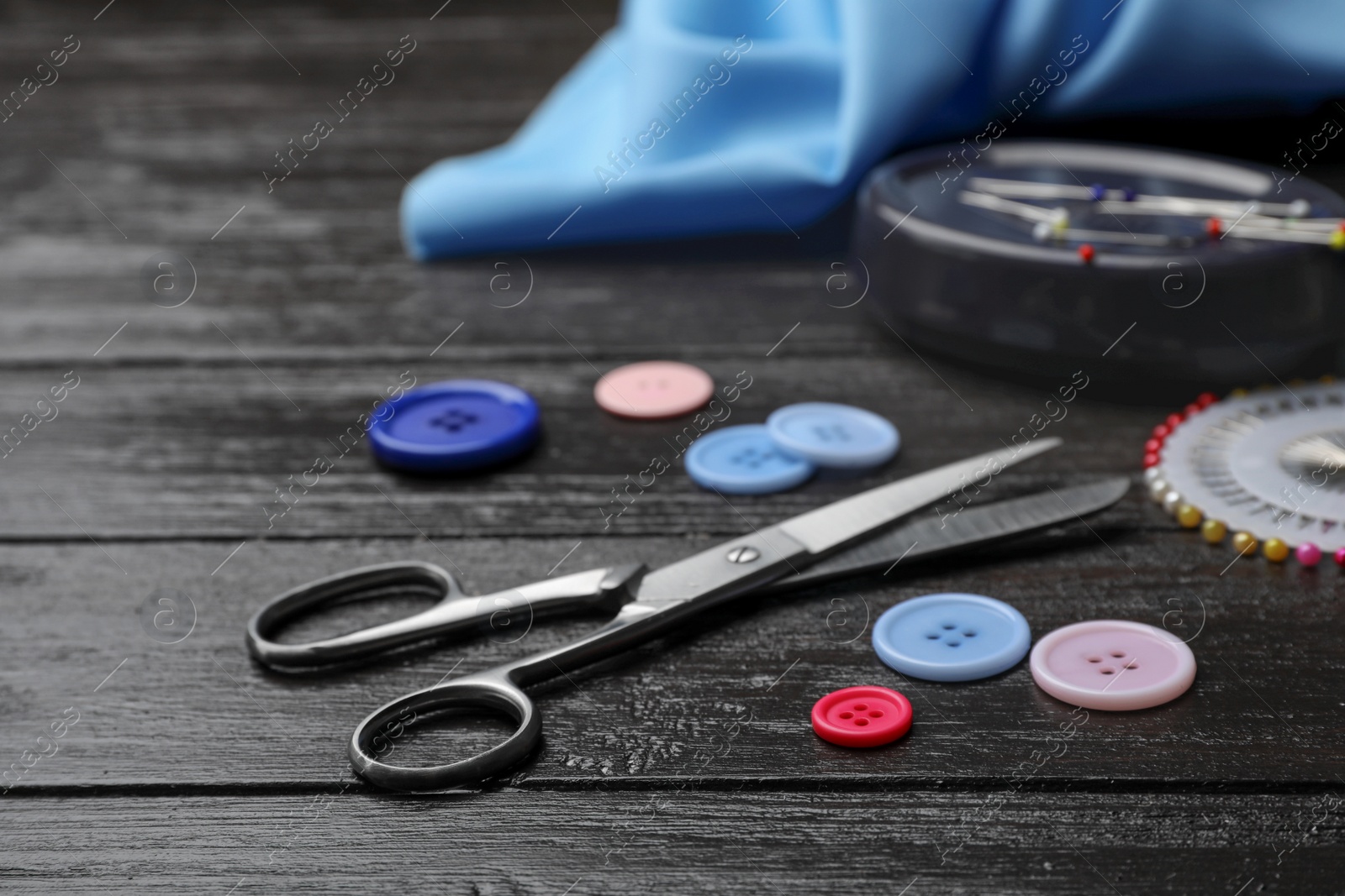 Photo of Composition with sewing accessories on wooden background