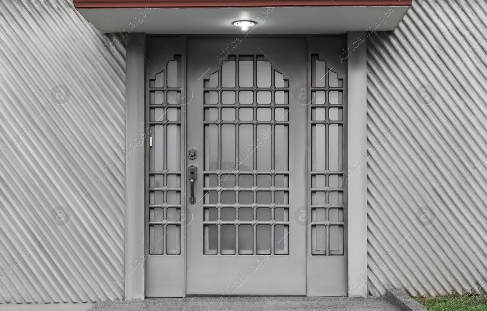 Photo of Closed door of modern building outdoors. Exterior design