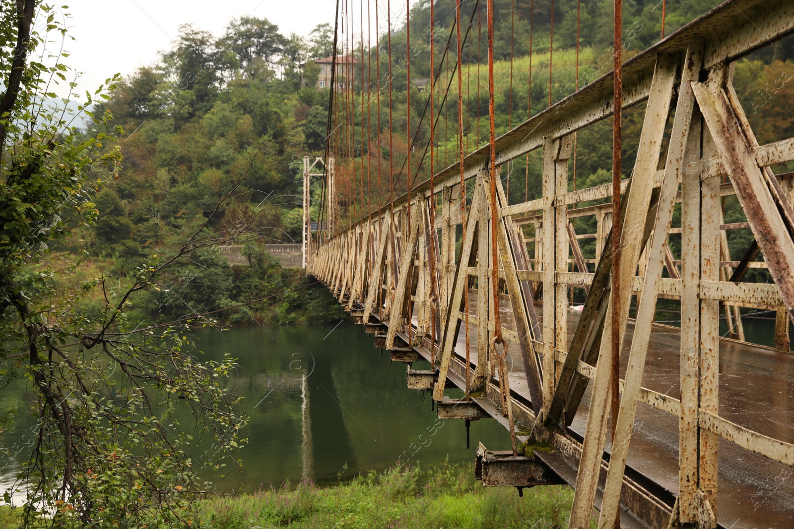 Photo of Beautiful view on rusty metal bridge over river in mountains