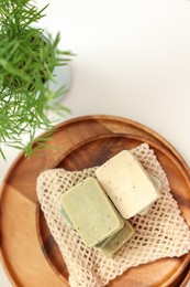 Photo of Soap bars and houseplant on white table, flat lay and space for text. Spa time