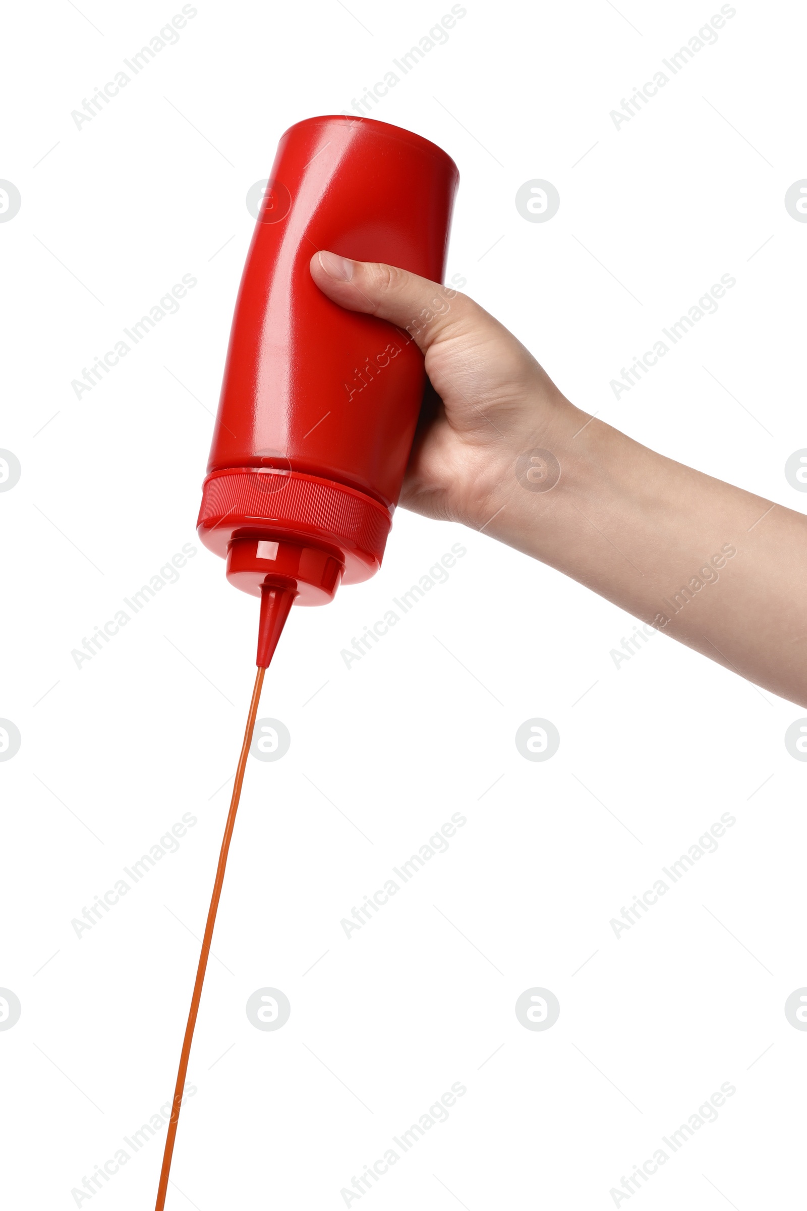 Photo of Woman pouring tasty ketchup from bottle on white background, closeup