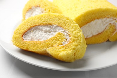 Photo of Delicious cake roll on white table, closeup