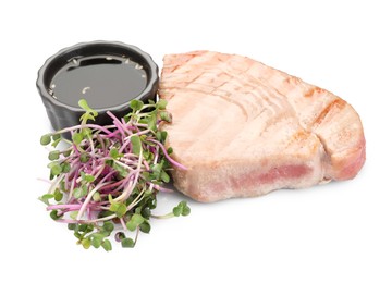 Photo of Delicious tuna steak with sauce and microgreens isolated on white