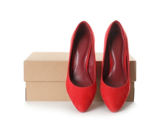 Photo of Pair of stylish shoes and carton box on white background