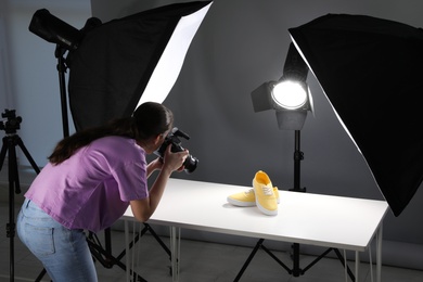 Photo of Professional photographer shooting stylish shoes in studio