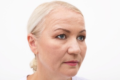 Portrait of beautiful older woman on white background