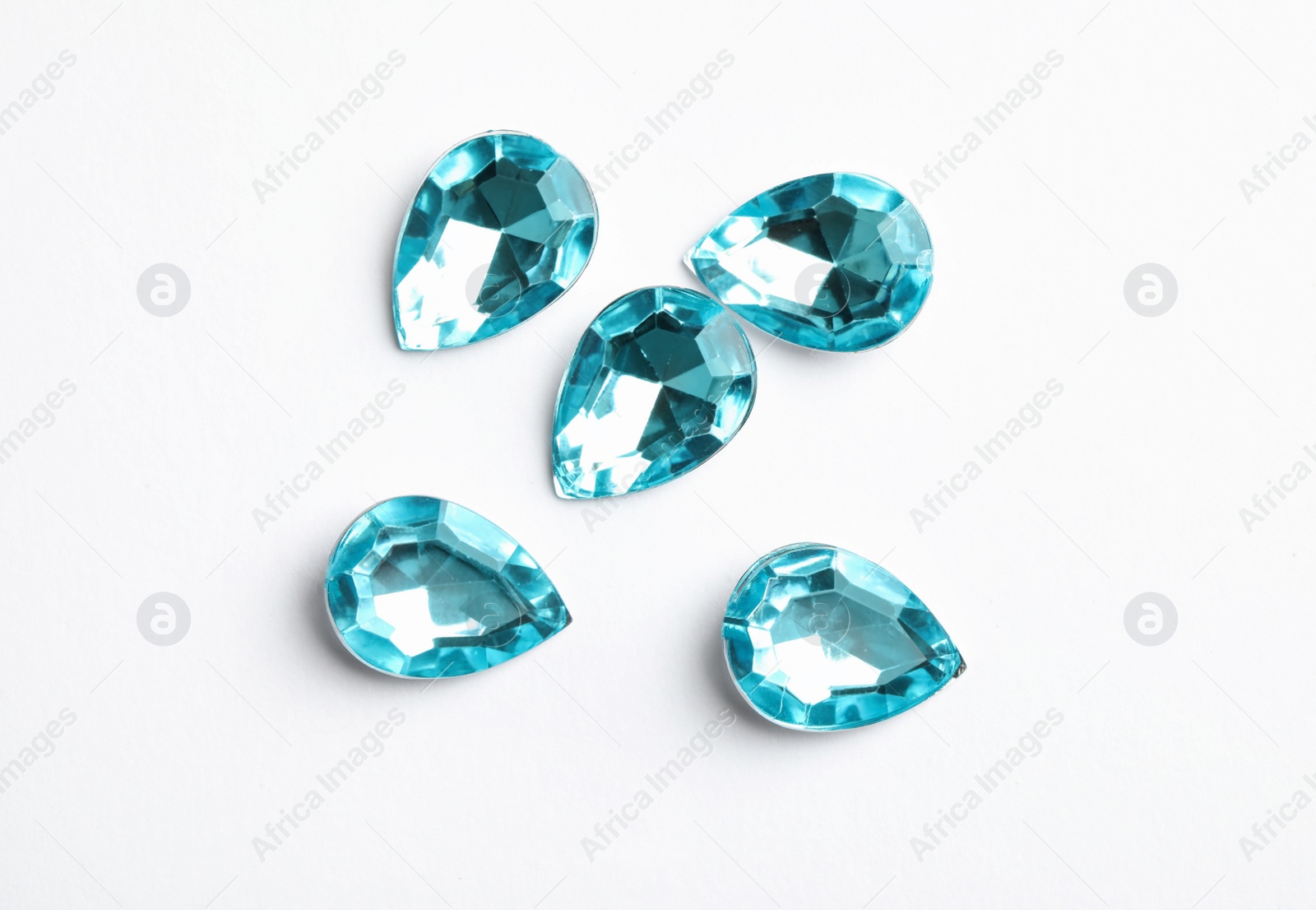 Image of Beautiful gemstones on white background, top view