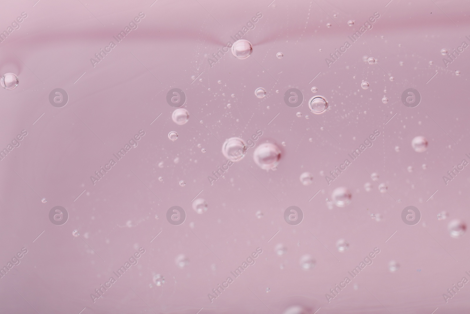 Photo of Pure transparent cosmetic gel on pink background, closeup