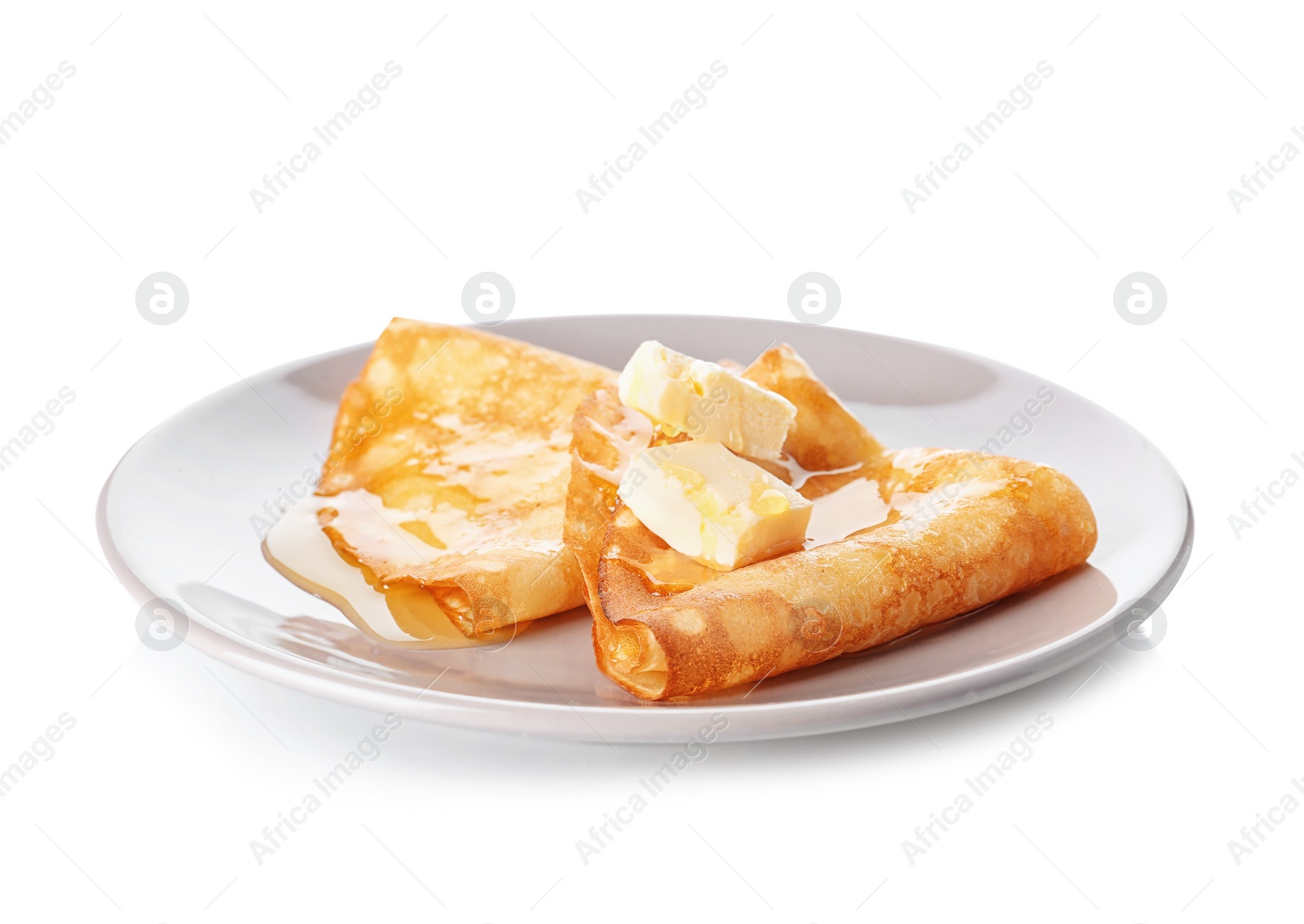 Photo of Plate with tasty thin pancakes, butter and maple syrup on white background