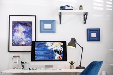 Photo of Home workplace with modern computer and desk in room