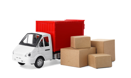 Photo of Toy truck with boxes isolated on white. Logistics and wholesale concept