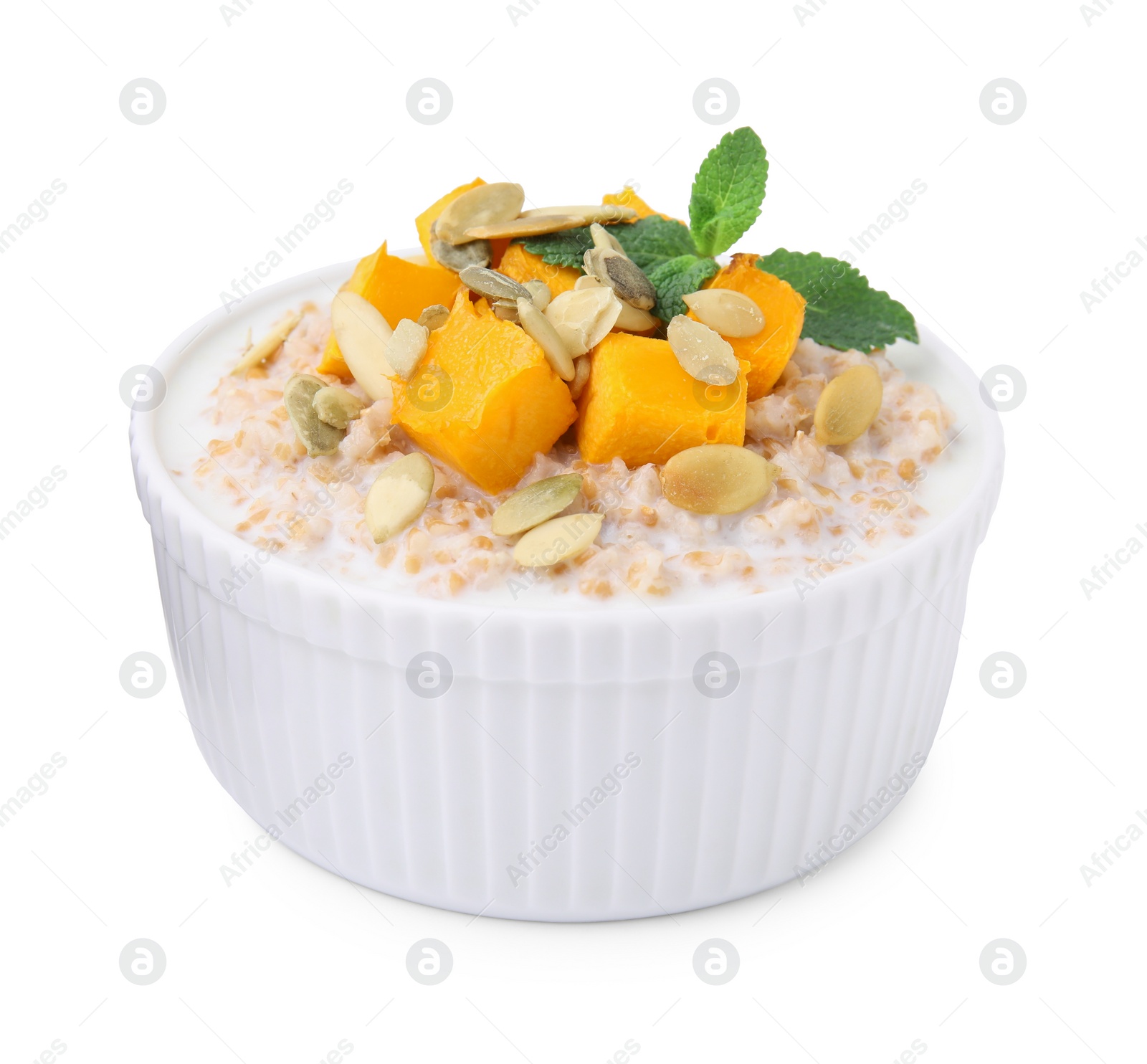 Tasty wheat porridge with pumpkin and mint in bowl isolated on white Photo of Tasty wheat porridge with pumpkin and mint in bowl isolated on white