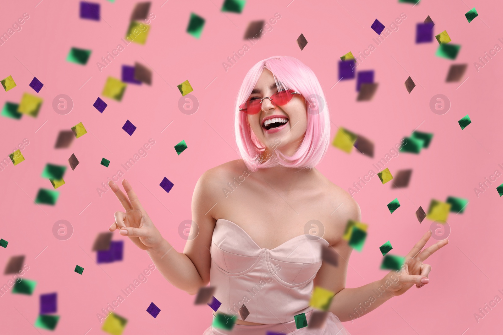 Image of Happy woman and flying confetti on pink background