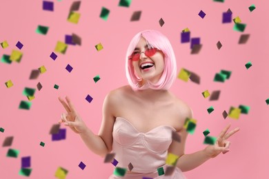 Happy woman and flying confetti on pink background