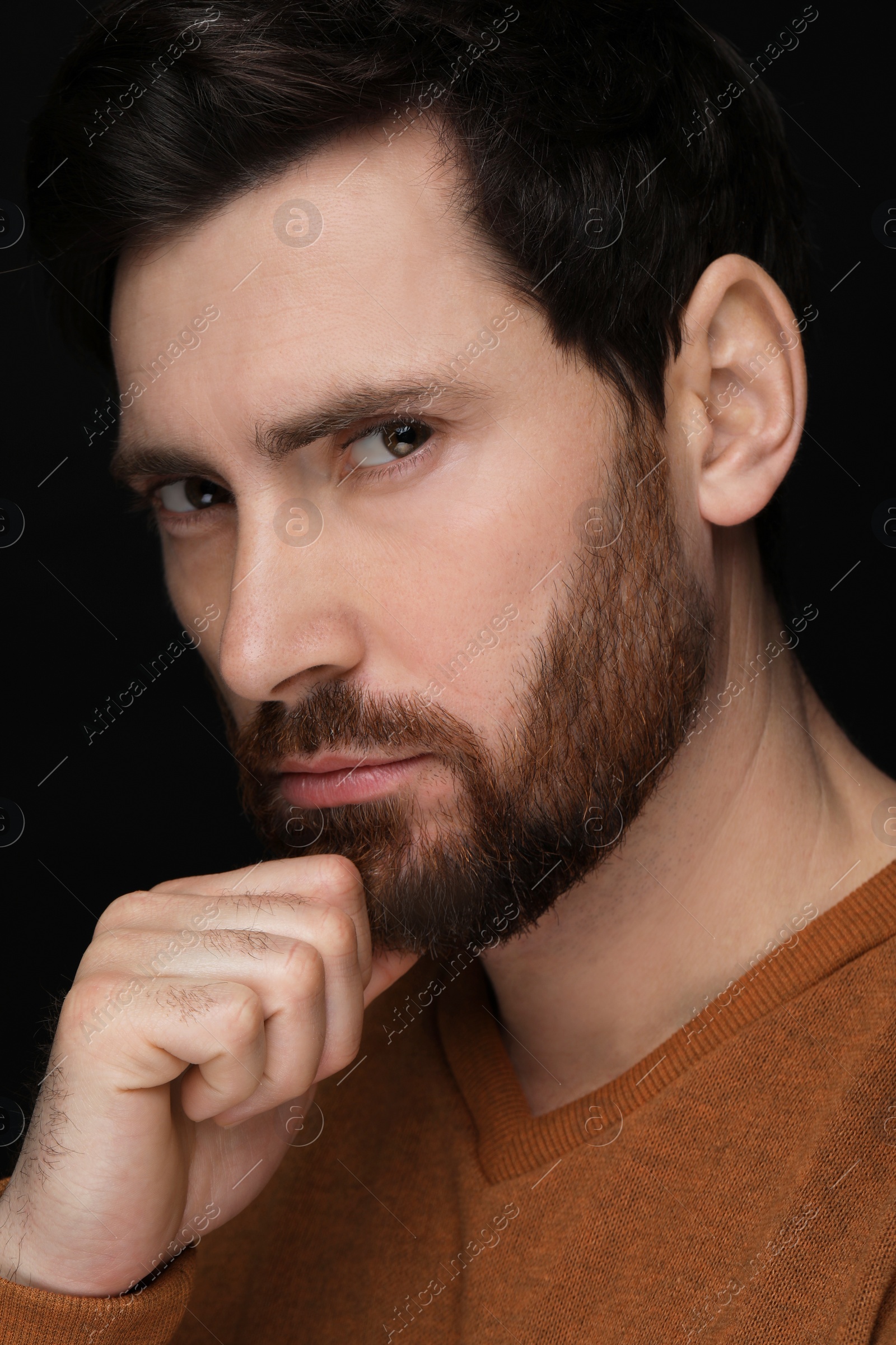 Photo of Evil eye. Man with scary eyes on black background, closeup