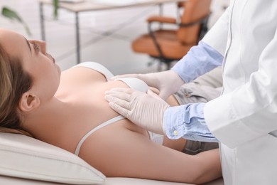 Photo of Mammologist checking young woman's breast in hospital