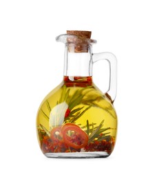 Glass jug of cooking oil with spices and herbs isolated on white
