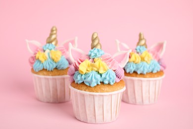 Cute sweet unicorn cupcakes on pink background