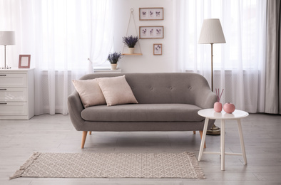Photo of Stylish sofa in beautiful living room interior