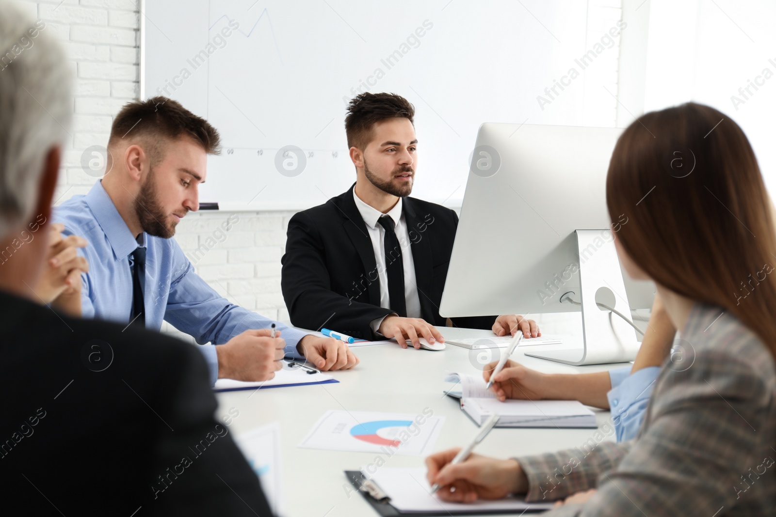 Photo of Professional business trainer working with people in office