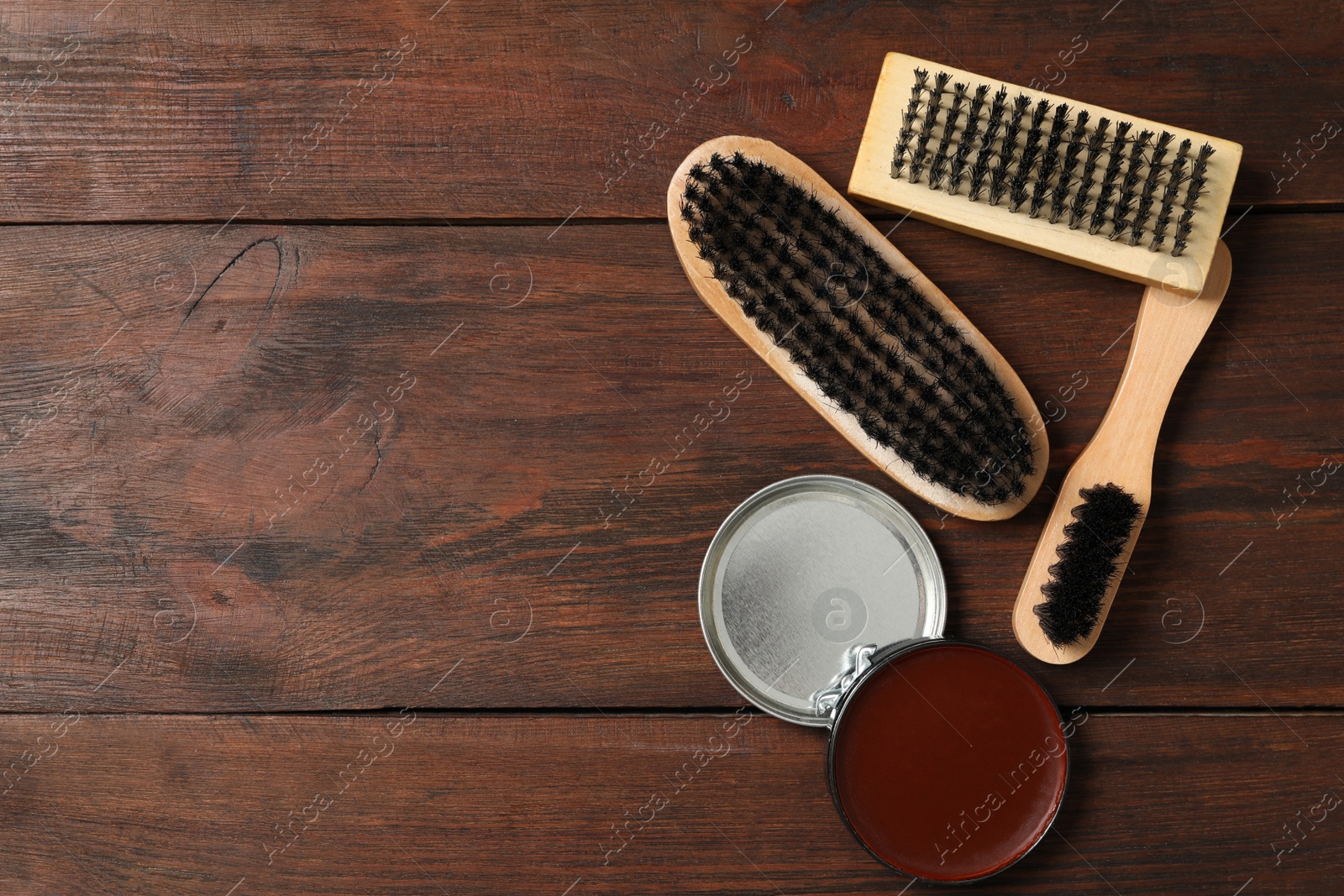 Photo of Flat lay composition with shoe care accessories on wooden background, space for text