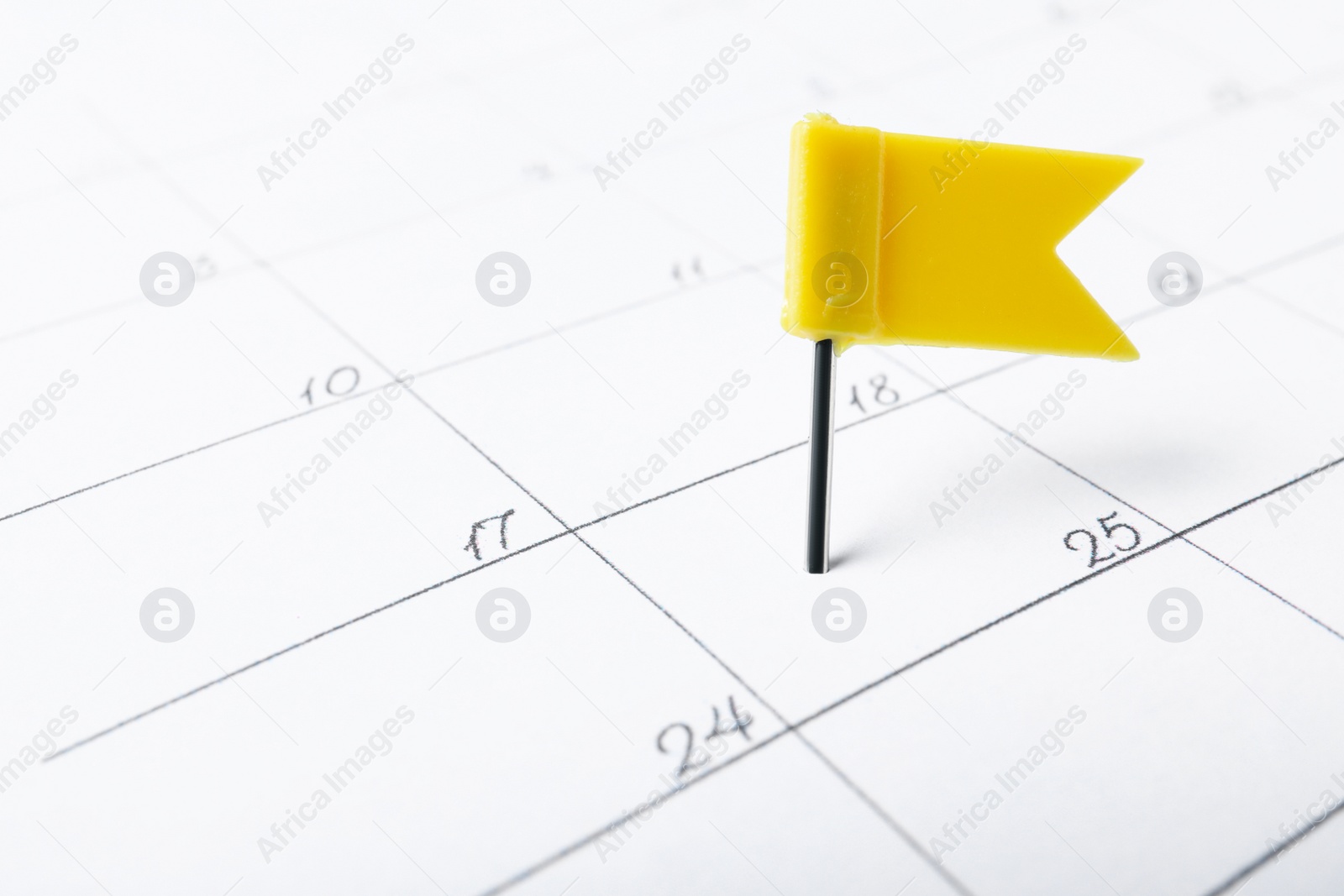 Photo of Calendar page marked with drawing pin, closeup