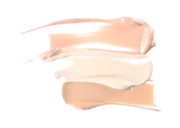 Different shades of liquid foundation on white background. Professional makeup products