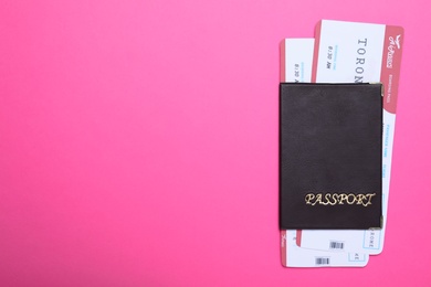 Photo of Passport with tickets on pink background, top view and space for text. Travel agency concept