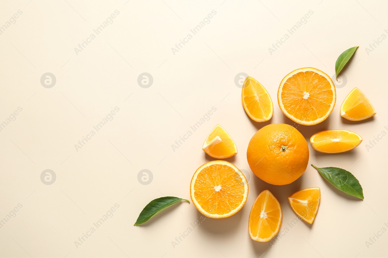 Photo of Flat lay composition with ripe oranges and space for text on color background