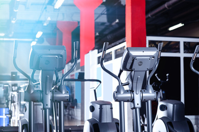 Photo of Elliptical trainers in gym. Modern sport equipment