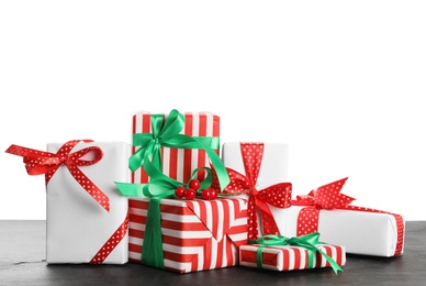 Photo of Many different Christmas gifts on table against white background