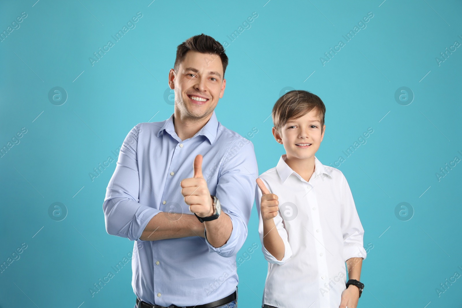 Photo of Portrait of dad and his son on color background