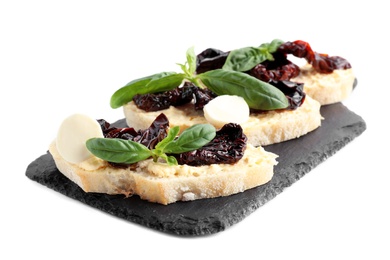 Slate plate of delicious tomato bruschettas on white background