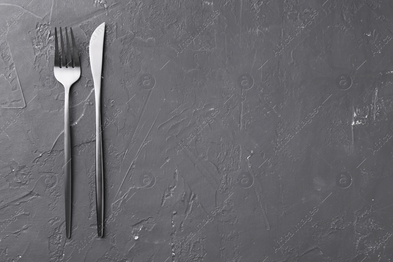 Photo of Beautiful cutlery set on black table, flat lay. Space for text