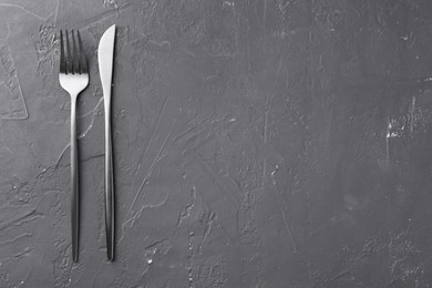 Photo of Beautiful cutlery set on black table, flat lay. Space for text