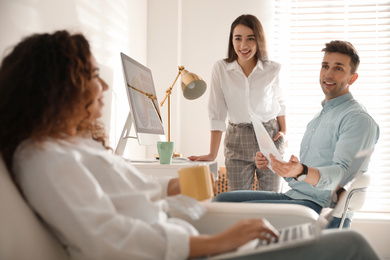 Photo of Team of professional designers working in office