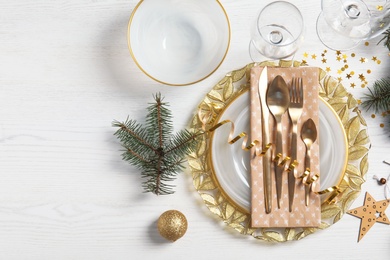 Elegant table setting and space for text on light background, top view. Christmas celebration