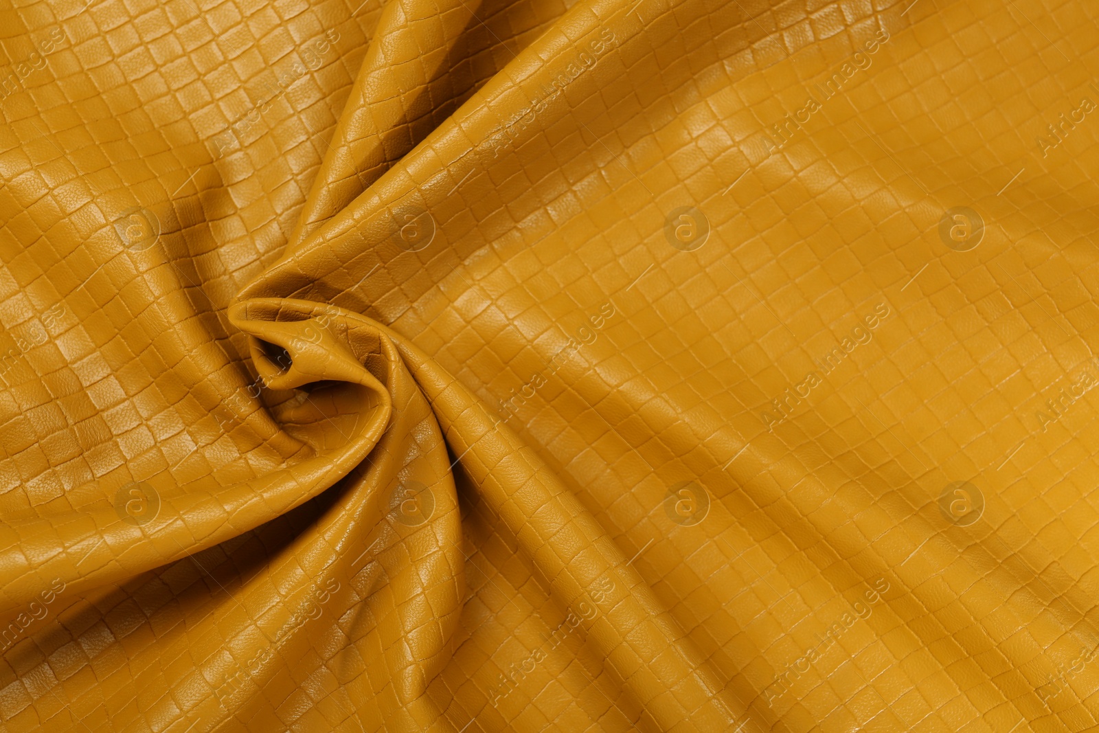 Photo of Beautiful yellow leather as background, top view