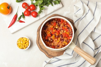 Flat lay composition with chili con carne on light background