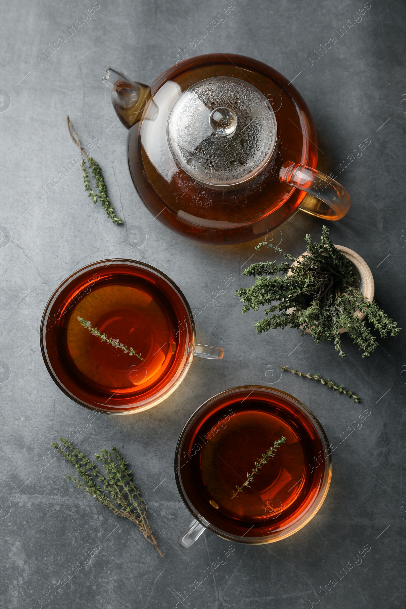 Photo of Aromatic herbal tea with thyme on grey table, flat lay