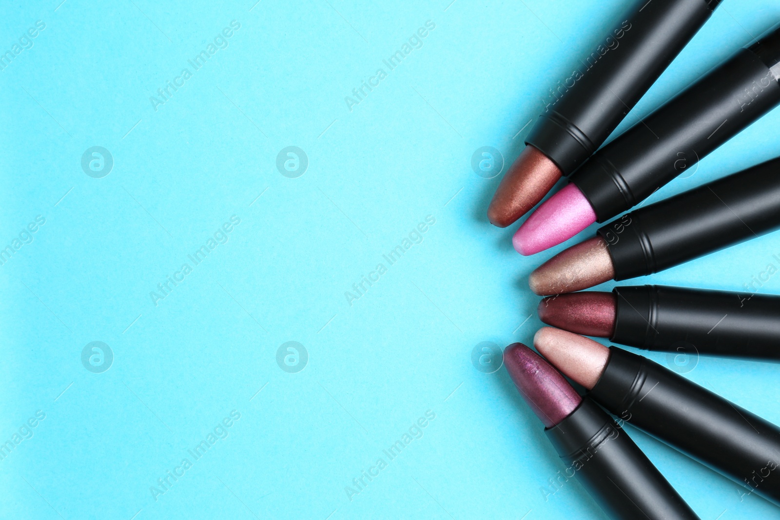 Photo of Flat lay composition with different stylish lipsticks on color background, space for text